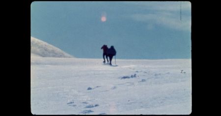Two people hike up slope in glacier.   (credit: Archival Materials Courtesy of Andri Snþr Magnason)