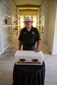 Coroner Scott McCord reflects on the casket containing Adam Doe's remains, which he had interred at his local mausoleum after seven years of trying unsuccessfully to find his family. (National Geographic/Tom Beard)