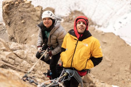 Climbers Alex Honnold, right, and Hazel Findlay assess the route ahead as they ascend Pool Wall in Eastern Greenland.  (photo credit: National Geographic/Pablo Durana)