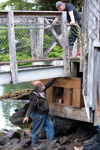 Terry Simpson and David Squibb repair a gangway. (National Geographic/Wes Waters)
