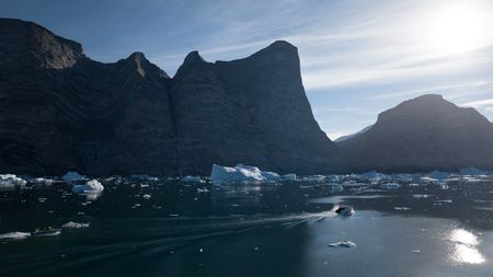 Alex Honnold and his team pass Ingmikortilaq by boat in Eastern Greenland.  (photo credit: National Geographic/Pablo Durana)