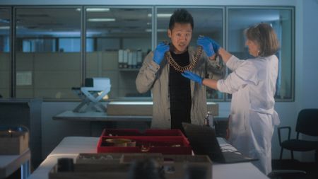 Juanita Saenz Samper presents Albert Lin with gold artifacts. (National Geographic)