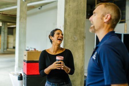 Diva Amon laughing with Mike Heithaus during a coffee break on the studio lab shoot. (National Geographic/Aubrey Fagon)