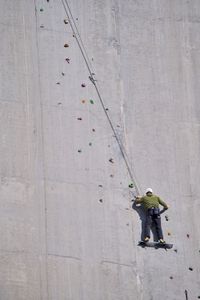 At the Luzzone dam in Switzerland, Chris rests on the platform at the start of three. He's made it to the sunlit area of the dam, and he needs to warm himself before taking on the next sections. (credit: National Geographic/Ben McGeorge-Henderson)
