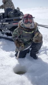 Asher Ulroan ice fishing with his grandparents. (National Geographic/Matt Kynoch)