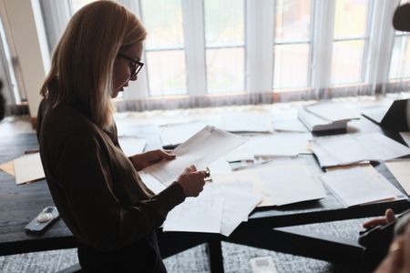 Mariana van Zeller reviews documents about rehab scammers. (National Geographic)