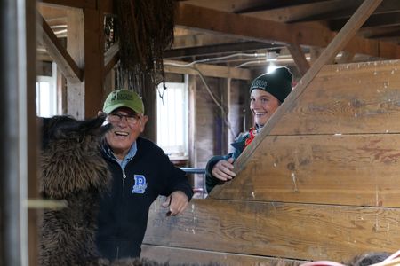 Brian Davis and Dr. Erin Schroeder laugh after they discover that his llama Cocoa's foot is not fractured after all. (National Geographic)