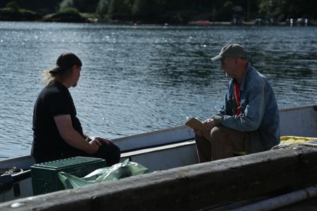 David Squibb and Sam Carlson take measurement's of Squibb's skiff, ahead of constructing a new fairlead for the boat. (National Geographic/Wayne Moss)