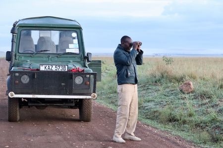 Spotter Driver Joseph Mwangi scans the landscape for Summer's Pride on a morning when the lions seem determined to remain hidden. (National Geographic/Alice Owen)