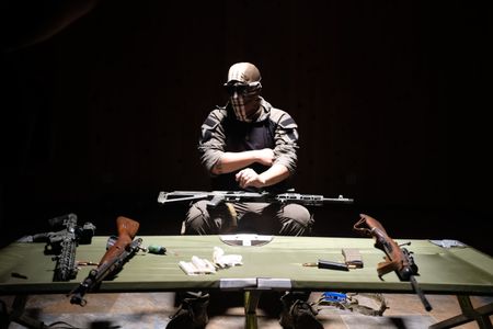 Black Cat Rifle Group co-founder El Gato showcases weaponry. (National Geographic)