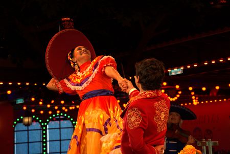 Performers strike a pose on stage in Plaza de Coco, the new entertainment restaurant on the Disney Treasure.  (credit: National Geographic/Matt Perez)