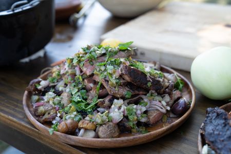 TX - Dry rubbed grilled ribeye finished with a chimichurri and served with pan fried potatoes. (Credit: National Geographic/Justin Mandel)