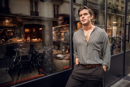 Antoni Porowski leans against the window at FIEF restaurant. (National Geographic/Amy Browning)