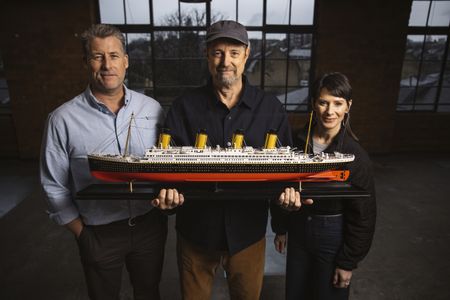 Chris Hearn, Parks Stephenson, and Jennifer Hooper stand with a model of RMS Titanic. (National Geographic/Freddie Claire)