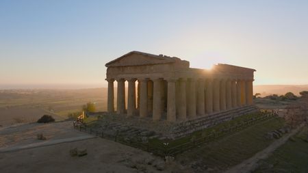TUCCI IN ITALY - “Sicily” - Aerial view of the sun setting behind the Temple of Concord in Agrigento’s Valley of Temples. (National Geographic)TUCCI IN ITALY