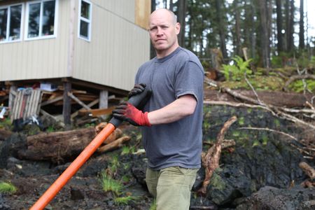 Troy Brockway constructs a ramp from the beach up to his property. (National Geographic/Gil Cano)