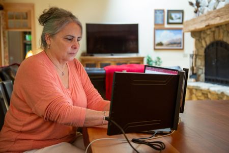 DNA Doe Project volunteer Rebecca Somerhalder researches the case at home. (National Geographic/Tom Beard)