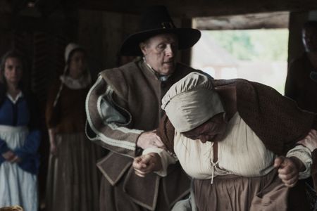 A village woman defeated, held at the arms of two men, after being condemned guilty of witchcraft.   (Dash Productions Services LTD/Antoan Ivanov)