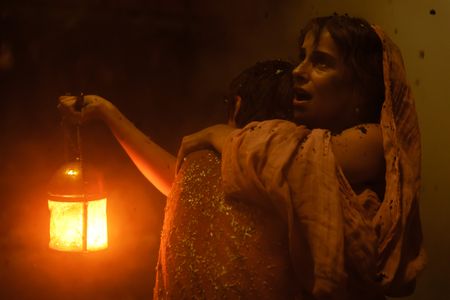 Avianius, played by Frankie Treadaway, and his mother Claudia, played by Madeleine Walker, embrace in the dark, ash-clogged street of Pompeii. (National Geographic/Darrin Zammit Lupi)