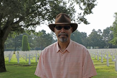 Stephen Woodson, son of Waverly Woodson Jr., is pictured during a visit to the Normandy American Cemetery in France. Waverly Woodson Jr. was a combat medic who served with the 320th Barrage Balloon Battalion on D-Day. (National Geographic/Shianne Brown)