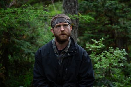Oliver Johnson gets a lesson in logging from his experienced neighbor. (National Geographic/Lukas Taylor)