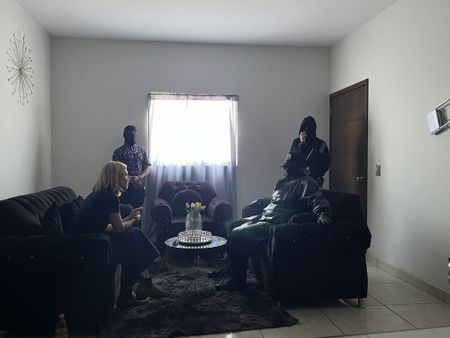 Mariana van Zeller interviews Sammi while his men guard the room. (National Geographic)