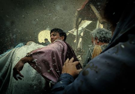 A Pompeii civilian battles his way through the crush of people rushing to evacuate the city of Pompeii as ash falls from the sky. (National Geographic/Darrin Zammit Lupi)