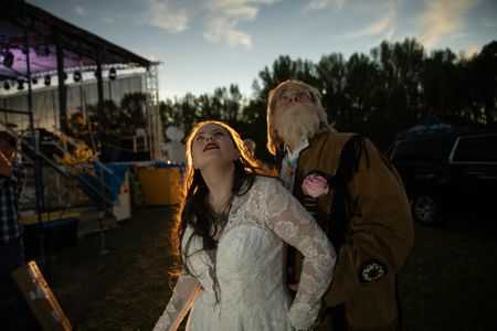 Bill Hyde and Angelica Grimes watch as the solar eclipse nears totality. Viewing a partial eclipse can damage the retinas, necessitating protective eyewear, though it's not required during the moments of a total solar eclipse because the moon completely obscures the sun’s rays. (Credit: Aaron Huey)