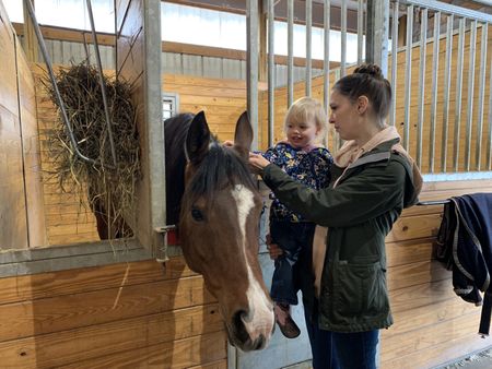 Abigail Pol and Beth Pol pet a horse at Yoke Farms. (National Geographic)