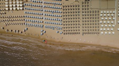 TUCCI IN ITALY - “Le Marche” - A stunning aerial view of Senigallia’s beach, with rows of colorful sun umbrellas lining the shore. (National Geographic)TUCCI IN ITALY