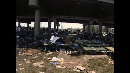 Stranded New Orleans residents gather underneath the interstate following Hurricane Katrina in 2005. (KTVT-TV)