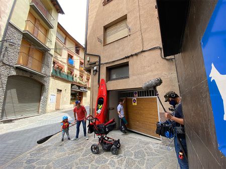 Gerd Serrasolses, Ali Casas, and their children get kayaks out from the garage on their way to the river in Sort, Spain.  (National Geographic/Gene Gallerano)