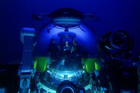 Crew Mario Tadinac, Dave Pollock, and David Reichert sitting inside the submarine floating in water. (National Geographic/Mario Tadinac)