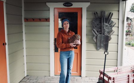 Head baker Celine Underwood poses for a portrait holding one of her signature loaves outside Brickmaiden Breads in Point Reyes, Calif. (National Geographic/Ryan Rothmaier)