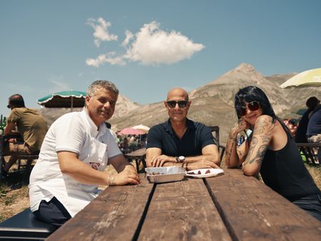 Stanley discovers unexpected delights in this wildest of regions, Abruzzo, one heìs never visited before. He stops at an iconic BBQ joint called Ristoro Mucciante and eats with Rodolfo Mucciante, left, and food and motor journalist Cristina Bachetti, right.  (credit: National Geographic/Matt Holyoak)