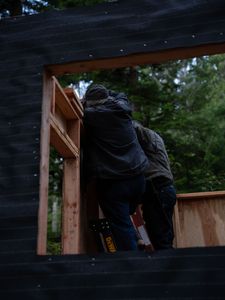 Terry Simpson is grateful for his friend David Squibb's help in building him a new cabin. (National Geographic/Robert Jolley)