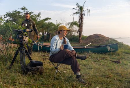 Sabine Henry enjoys a rest on the banks of the Kagera River in Rwanda. (National Geographic/Philip Jones)