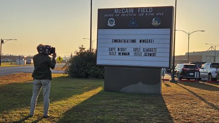 DOP Jon Southgate-Sayers captures the congratulations sign for some of the students the film crew followed on the day of their Winging. (National Geographic/Lyndsi Gutierrez)