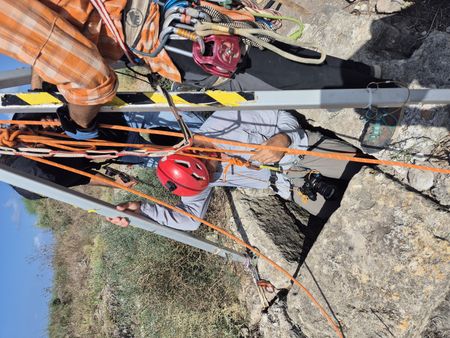 In this behind-the-scenes photo, crew members get ready for geoarchaeologist Beverly Goodman's descent down a well, to search for evidence to accurately date it, in Caesarea, Israel. (Windfall Films)