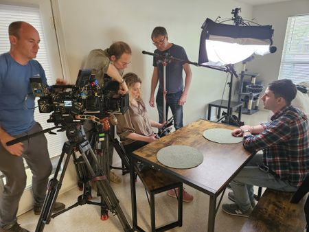 Camera Charlie Laing, DOP Jon Southgate-Sayers, director Lana Salah, sound recordist Phil Bax and student LTJG Marcus Figueroa getting ready for an interview. (Credit: National Geographic/Lyndsi Gutierrez)