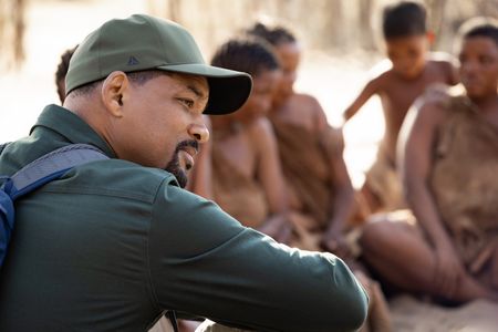 Will Smith sits and talks with the San people in the Kalahari Desert.  (credit: National Geographic/Kyle Christy)