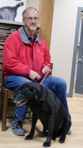 Owner Mike Reifenrath picks up his dog Suh after surgery. (National Geographic)