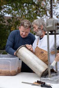 Michigan - Captain Ron (R) teaches Gordon Ramsay how to make smoked fish sausage in Michigan. (Credit: National Geographic/Justin Mandel)