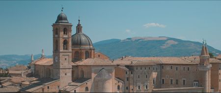 TUCCI IN ITALY - “Le Marche” - Aerial view of Urbino’s iconic Palazzo Ducale, with the rolling hills of the countryside in the background. (National Geographic)TUCCI IN ITALY