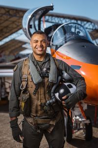 Portrait of student Captain Micah Nissly next to a T-45. (Credit: National Geographic/Freddie Claire)