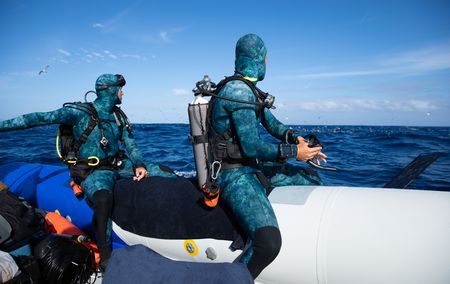 Underwater cameraman, Jeff Hester and host, Bertie Gregory, watching shearwaters at the water’s surface, a sign of a bait ball beneath.  (credit: National Geographic/Adam Boyle)