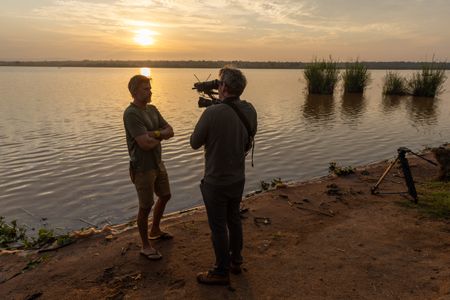 National Geographic Explorer Dr. Steve Boyes is filmed on the banks of the Kagera River in Rwanda. (National Geographic/Philip Jones)