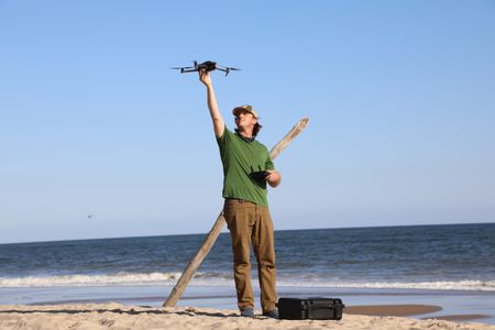 Tim Regan preparing for his drone to take off on the beach. (National Geographic/Mariana Kneppers)