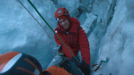 Alex Honnold struggles with a stuck rope in a moulin.  (photo credit: National Geographic/Pablo Durana)