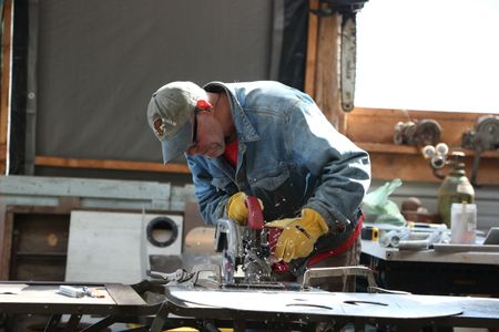 Sam Carlson constructs a new fairlead for his friend's skiff. (National Geographic/Wayne Moss)